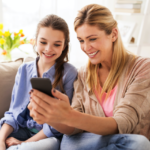 Mom and Daughter looking at Twigby phone