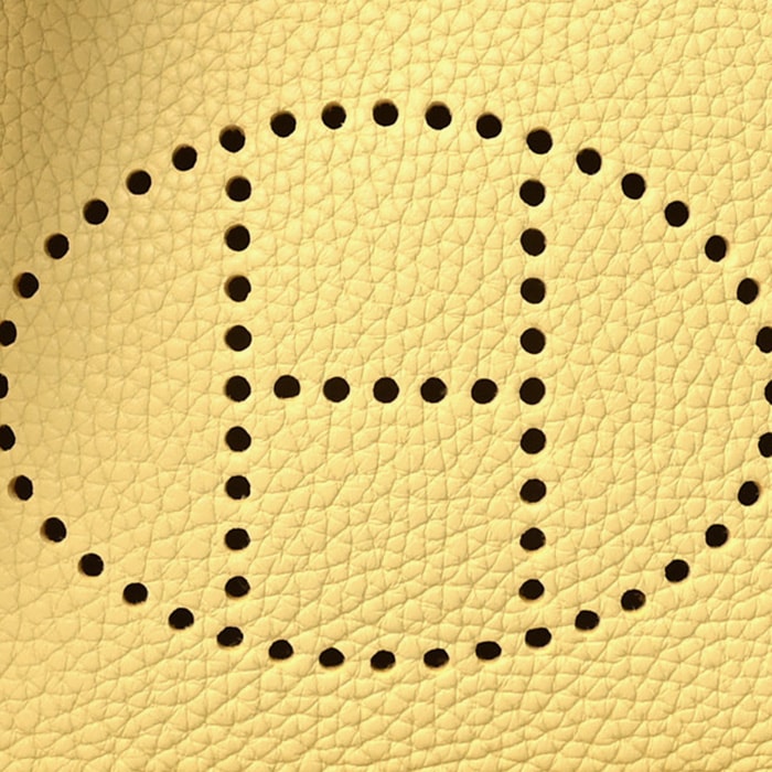 this is a close up swatch image by fashionphile of the hermes jaune poussin color on taurillon clemence leather