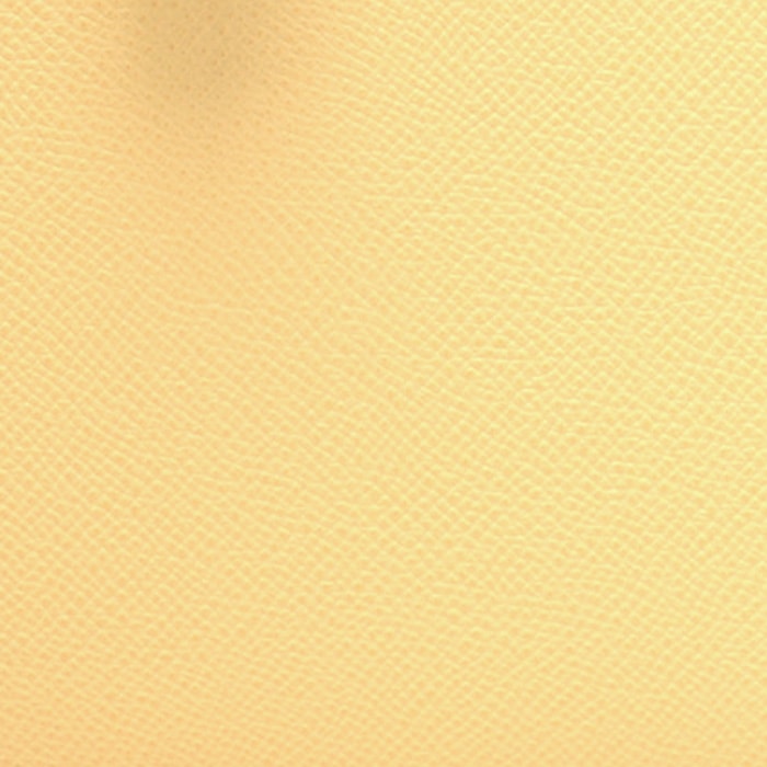 this is a close up swatch image by fashionphile of the hermes jaune poussin color on Epsom leather