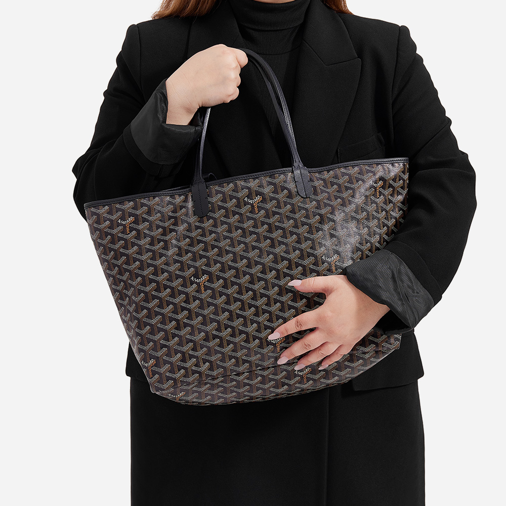model holding the goyard saint louis tote in size pm in the color black by FASHIONPHILE
