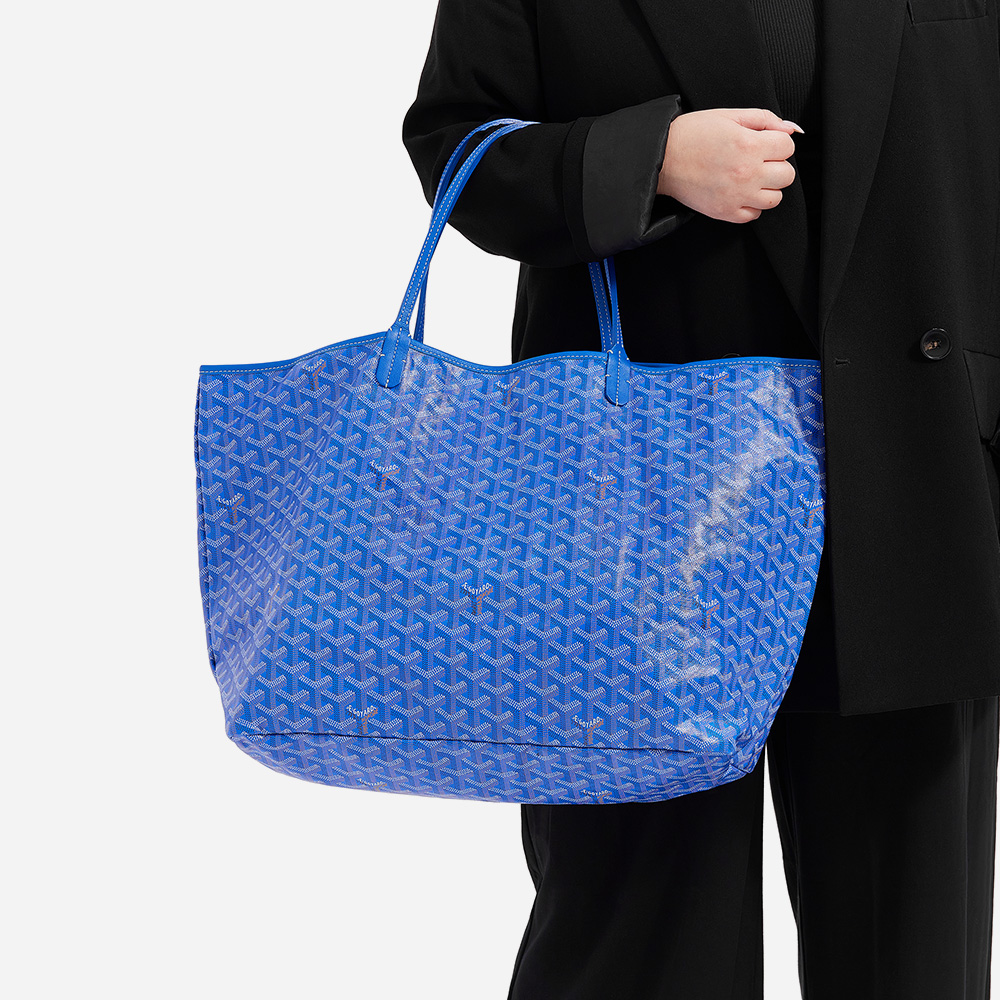 model holding the goyard saint louis tote in size gm in the color blue by FASHIONPHILE