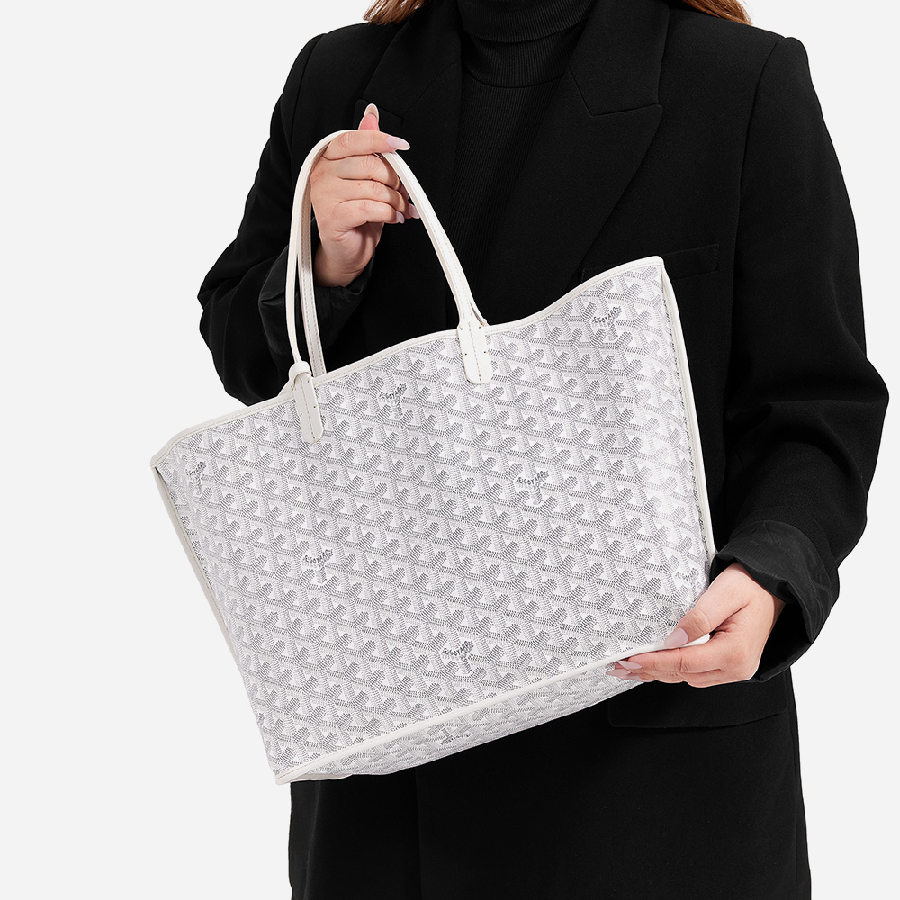 model holding the goyard anjou tote in the size pm in the color white by FASHIONPHILE