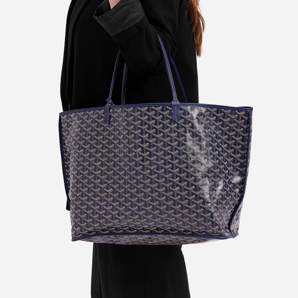model holding the goyard anjou tote in the size gm in the color navy by FASHIONPHILE