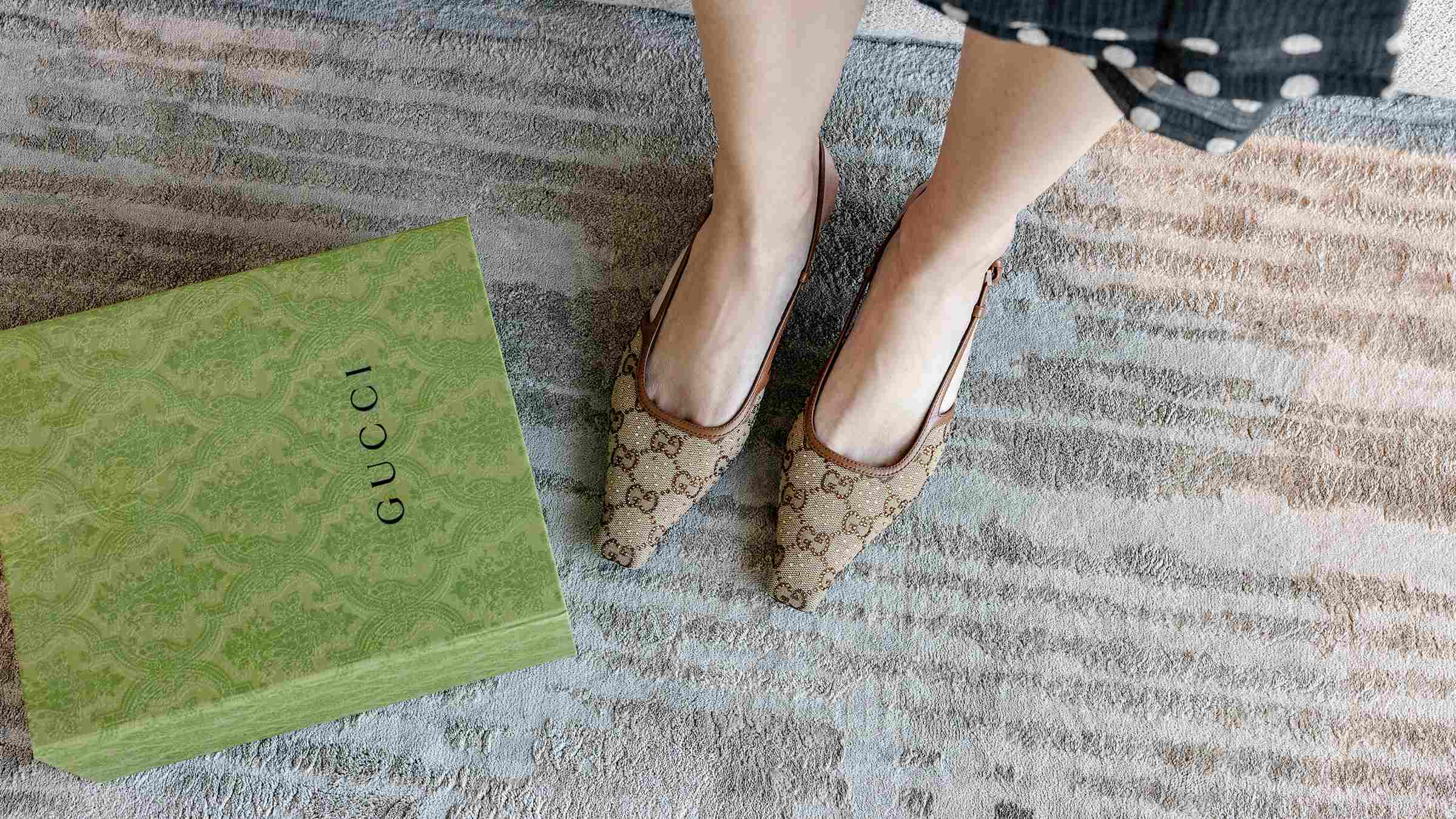 overhead image of girl wearing light brown crystal covered gucci heels with green gucci box by FASHIONPHILE