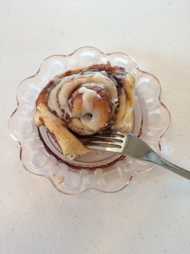 iced cinnamon roll on plate