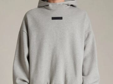 male model wearing a gray essentials hoodie