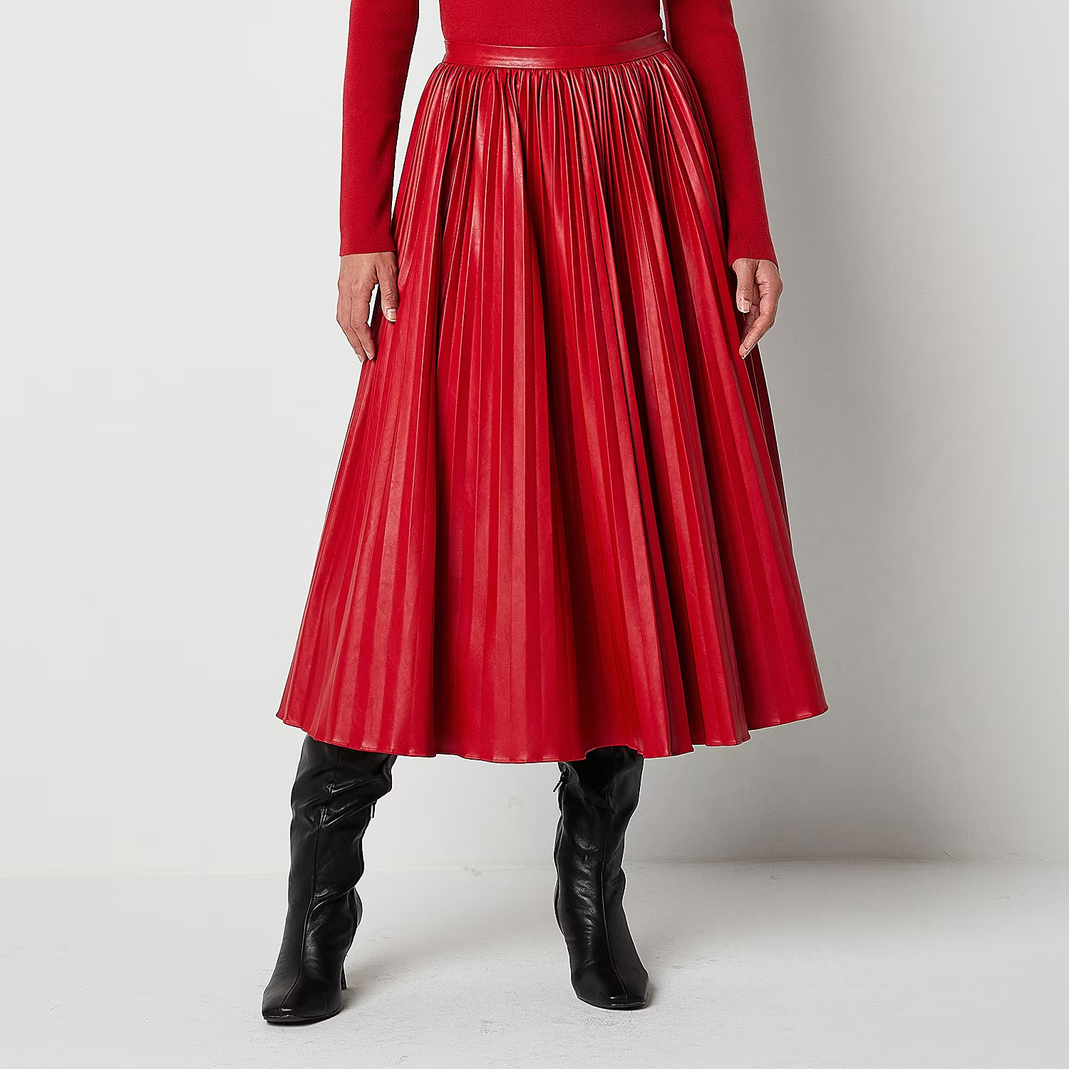 woman wearing red pleated skirt with tall black boots